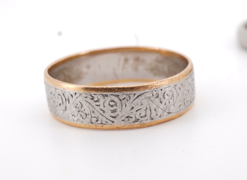 Three rings, comprising: a platinum wedding band, size N1/2, stamped PLAT, gross weight 3 grams; a bicoloured band, size J, stamped PLATINUM 22CT, gross weight 3 grams; and a ring set with a diamond weighing approximatel